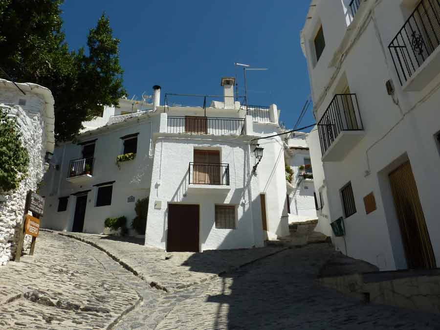 Village blanc en Andalousie, ruelle pavée bordée de maisons blanchies à la chaux sous le soleil espagnol avec tui voyage