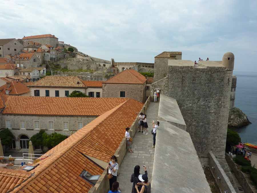 Promenade sur les remparts de Dubrovnik au-dessus des toits orangés, un moment idéal pour savoir quand partir en Croatie sans subir la foule